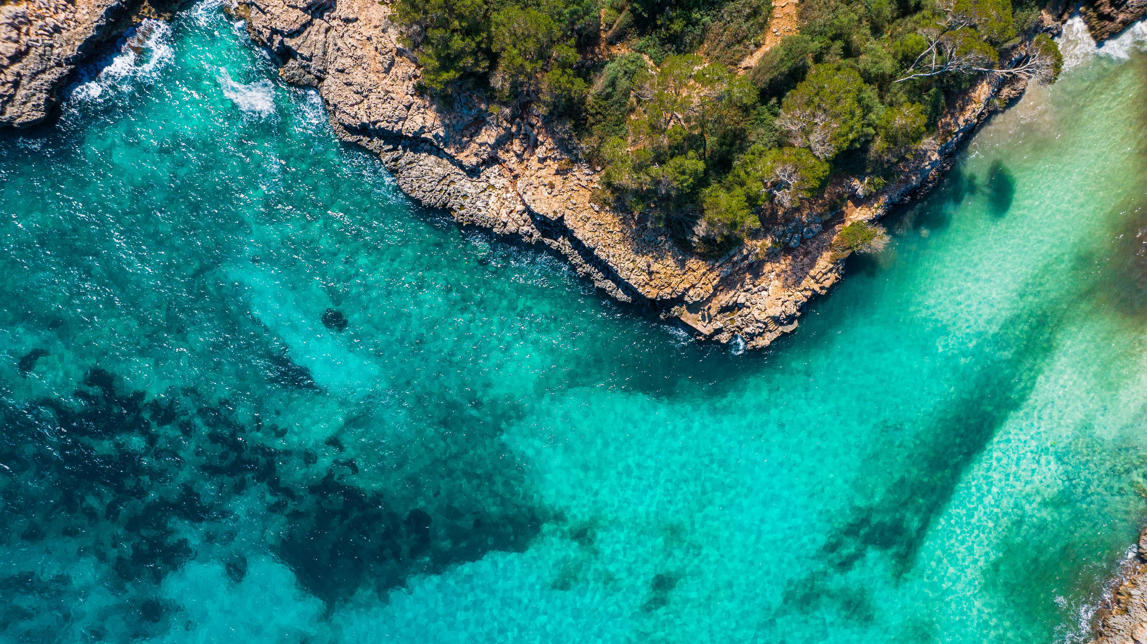 Aerial view of Mallorca coastline with turquoise water