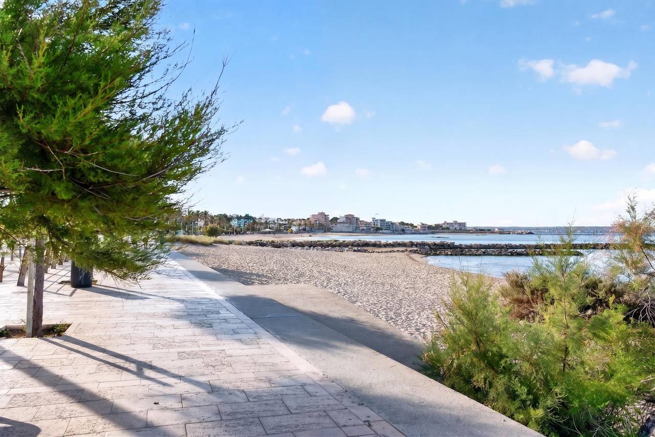 Seafront promenade and sandy beach in Ciutat Jardí, Palma